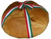 a loaf of bread with a red , white , and green ribbon around it .