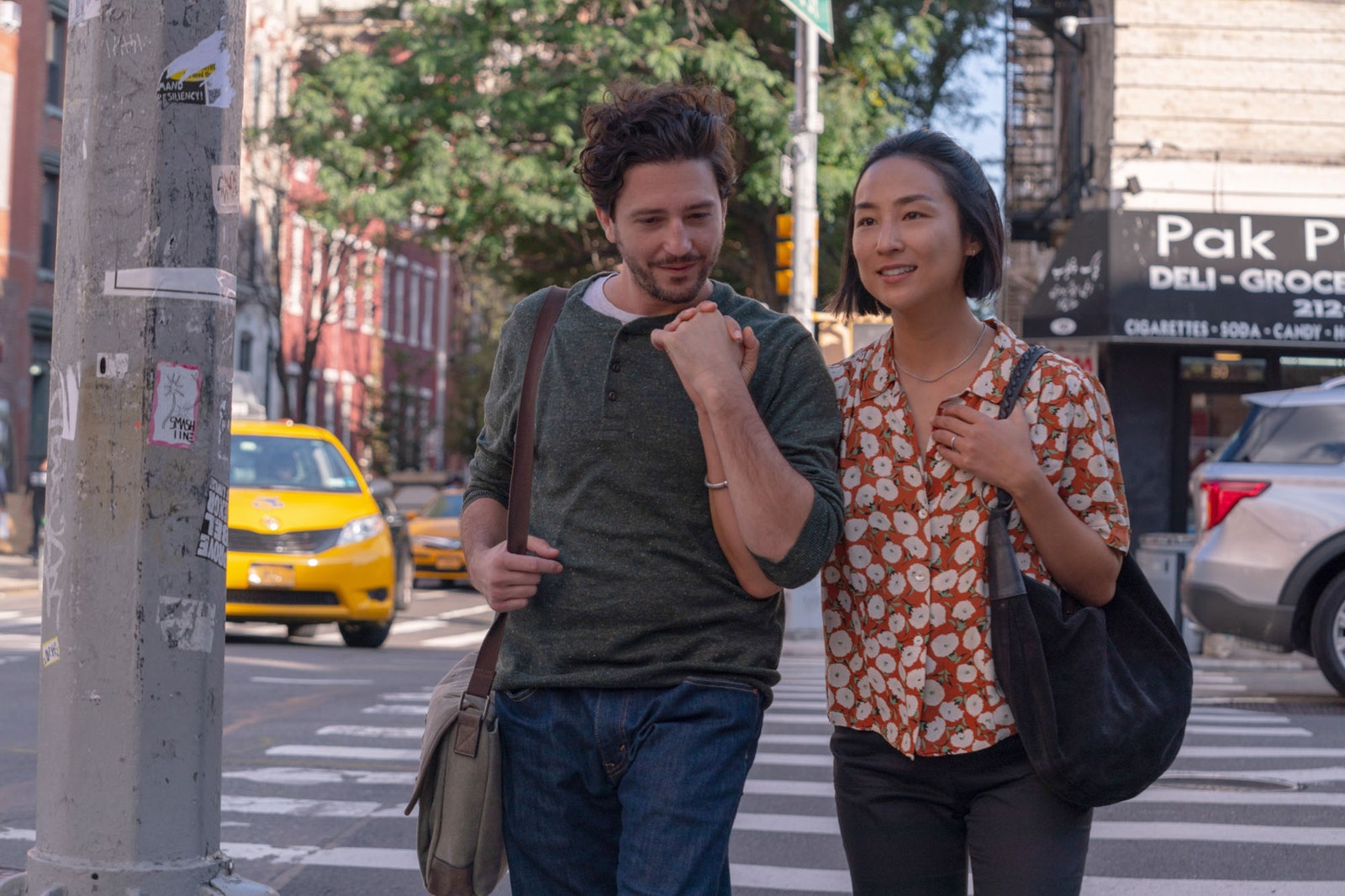 Image may contain Greta Lee John Magaro City Road Street Urban Adult Person Accessories Bag Handbag and Car