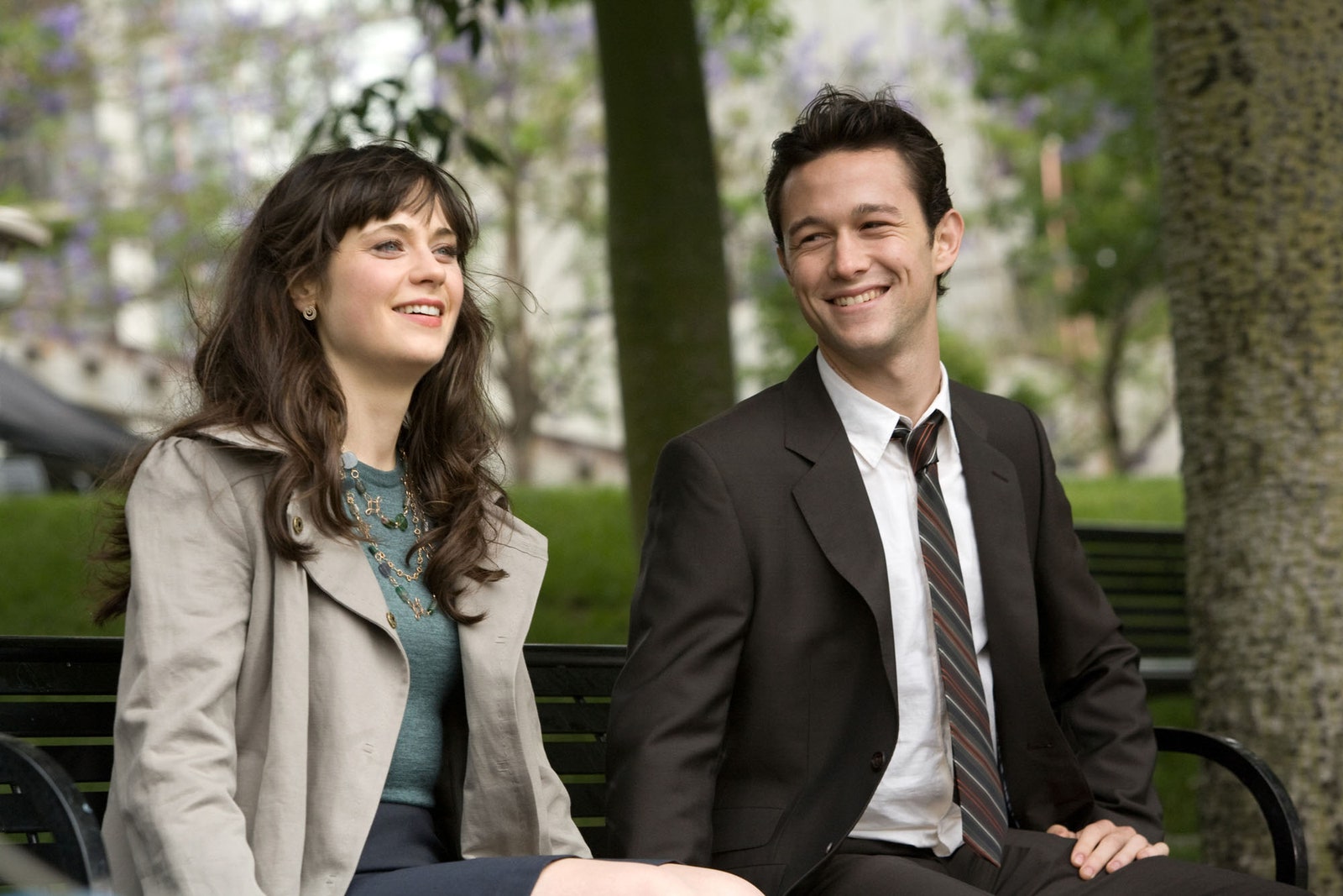 Image may contain Joseph GordonLevitt Zooey Deschanel Blazer Clothing Coat Jacket Bench Furniture and Accessories