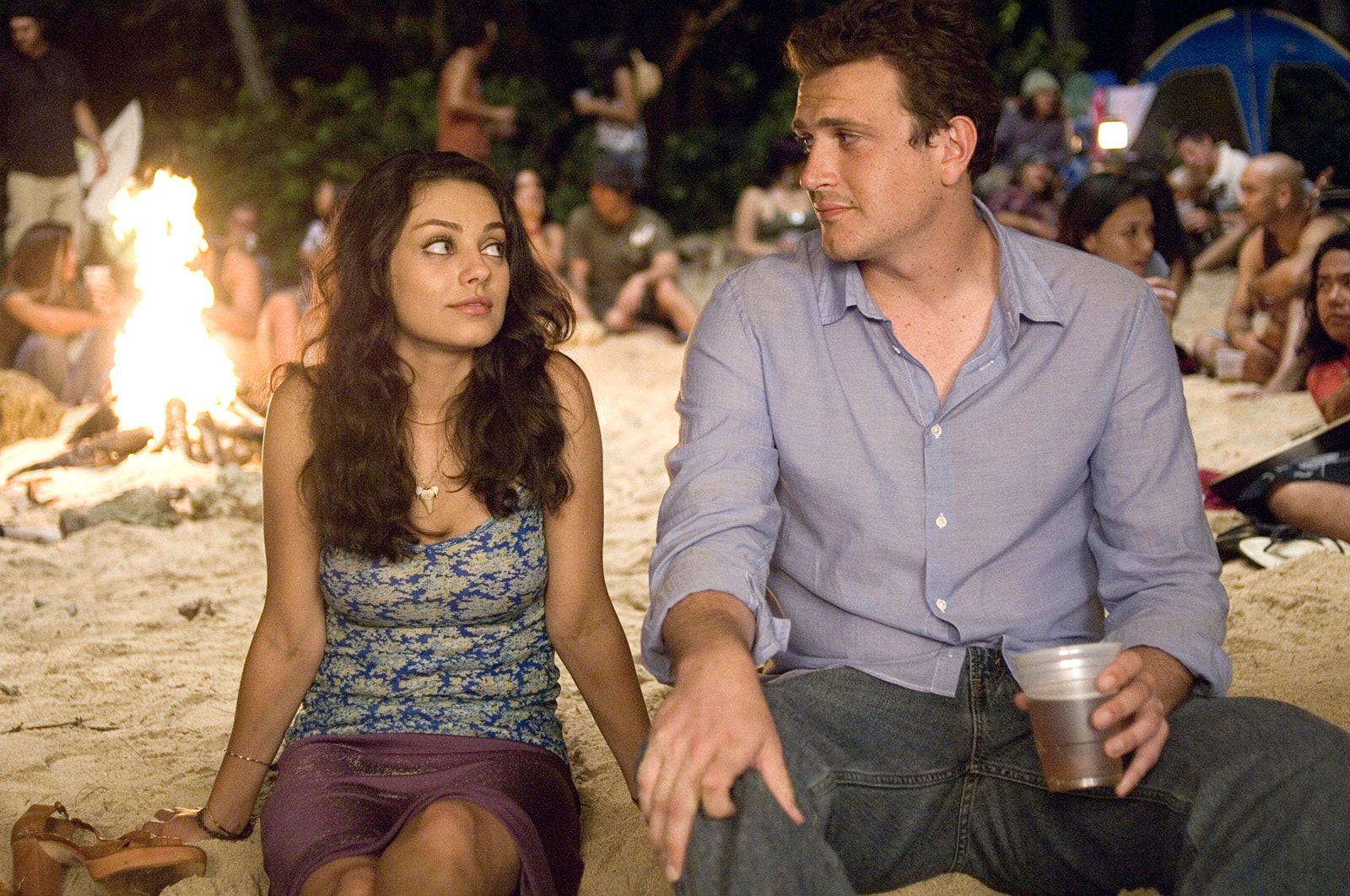 Image may contain Jason Segel Mila Kunis Fire Flame Cup Adult Person Accessories Jewelry Necklace and Dating