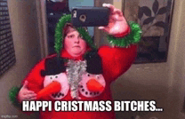 a woman wearing a christmas sweater is taking a selfie in a mirror .