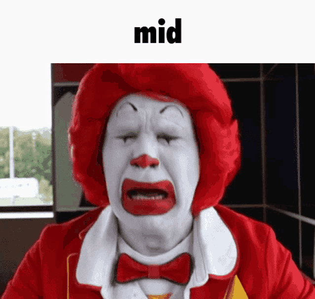 a mcdonald 's clown is crying with his eyes closed and a bow tie .