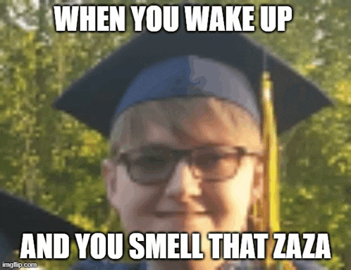 a boy wearing a graduation cap and gown is making a funny face and smelling that zaza .