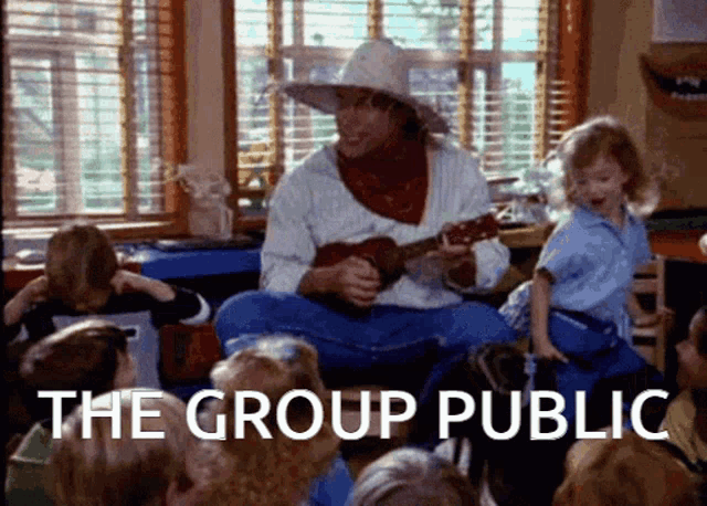 a man in a cowboy hat is playing a guitar in front of a group of children and the words the group public are visible