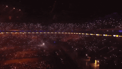 an aerial view of a crowd at a concert with a large screen behind them that says ' nbc '