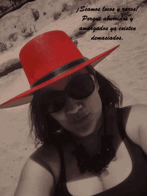 a woman wearing a red hat and sunglasses with a quote in spanish