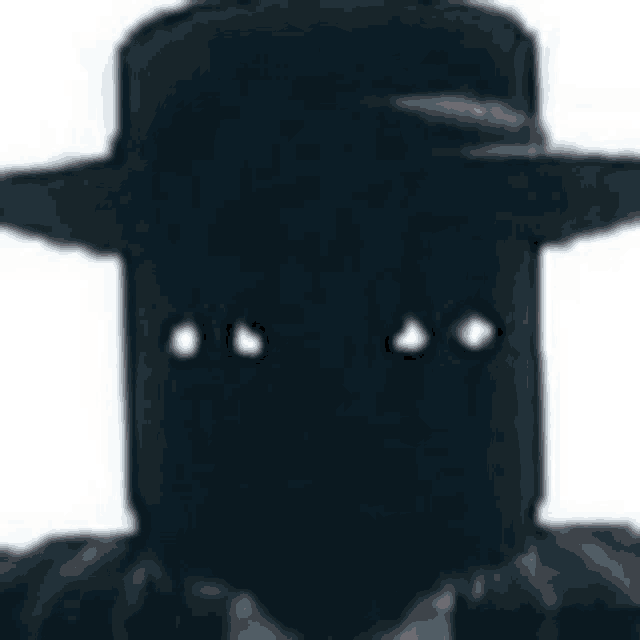 a close up of a person wearing a black hat and a mask .