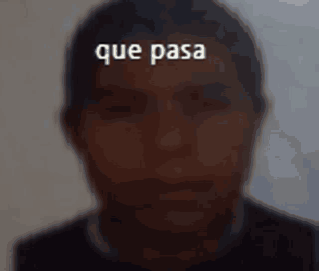 a blurry picture of a man 's face with the words que pasa above it