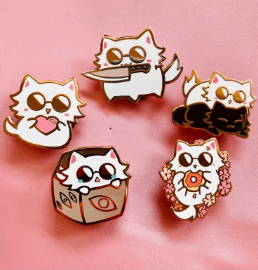 a bunch of pins of cats on a pink background