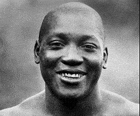 a black and white photo of a smiling shirtless man .