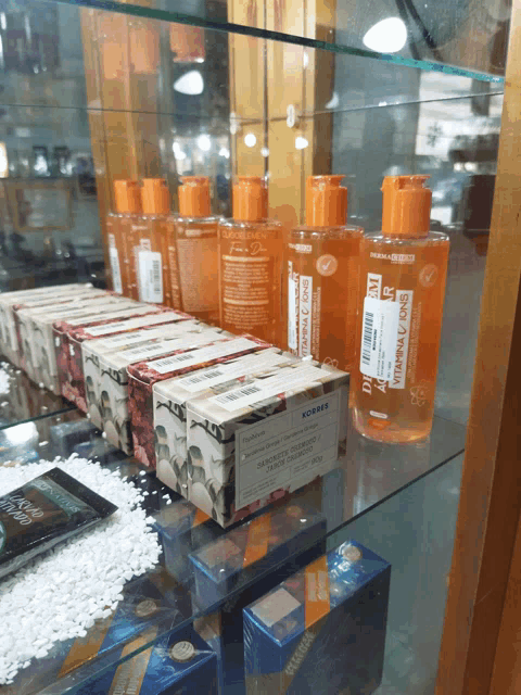 several bottles of vitamin c lotion sit on a shelf