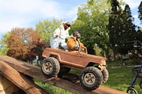 a toy jeep with a walker behind it