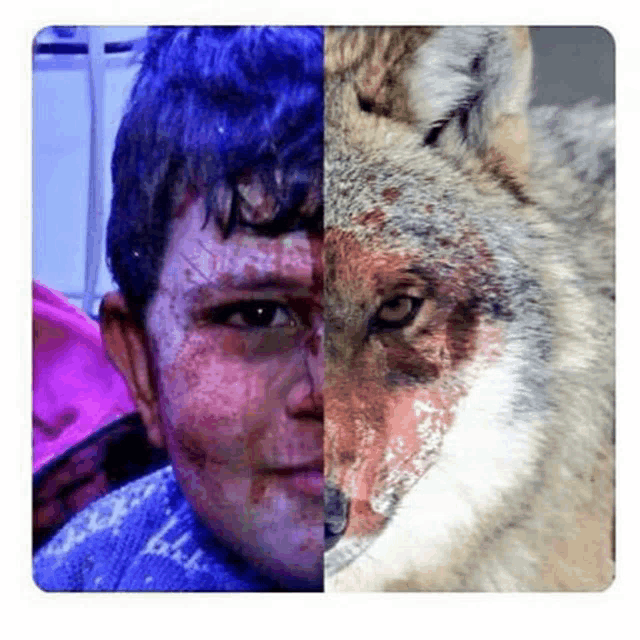 a man with blood on his face is next to a wolf