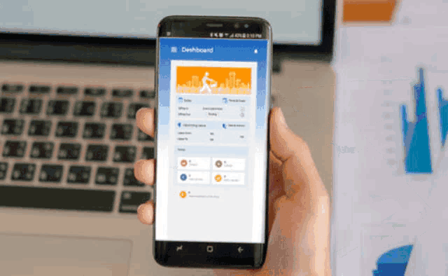 a person is holding a cell phone with a dashboard app on it