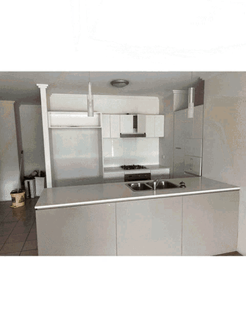 a kitchen with two sinks and a stove top oven