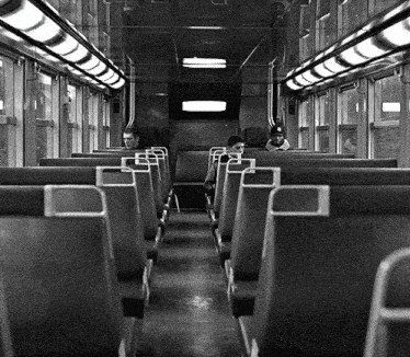 a black and white photo of people sitting on a bus with a sign that says ' a ' on it