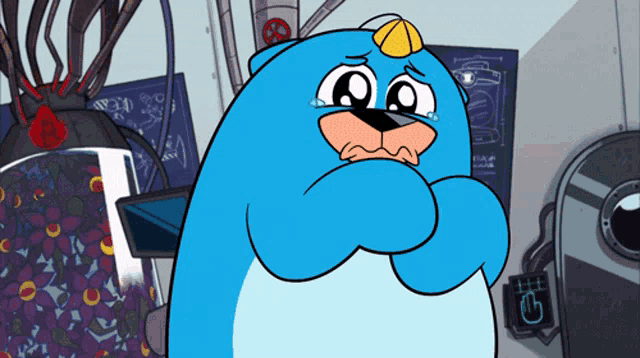 a blue cartoon character is crying with a yellow hat on