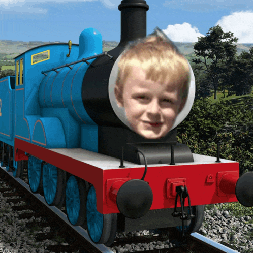 a blue train with a boy 's face on the front