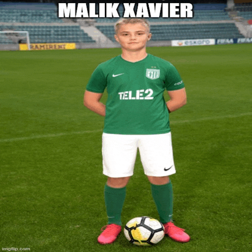 a soccer player named malik xavier stands on a field