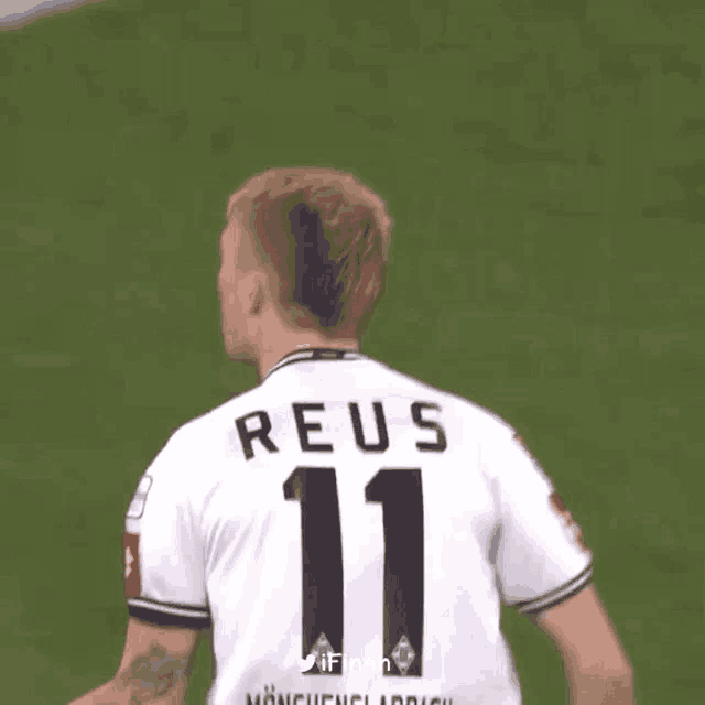 a soccer player wearing a white jersey with the number 11 on it