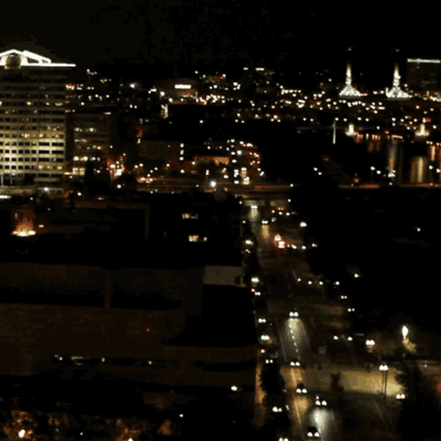 an aerial view of a city at night with a building that says ' chase ' on the top of it