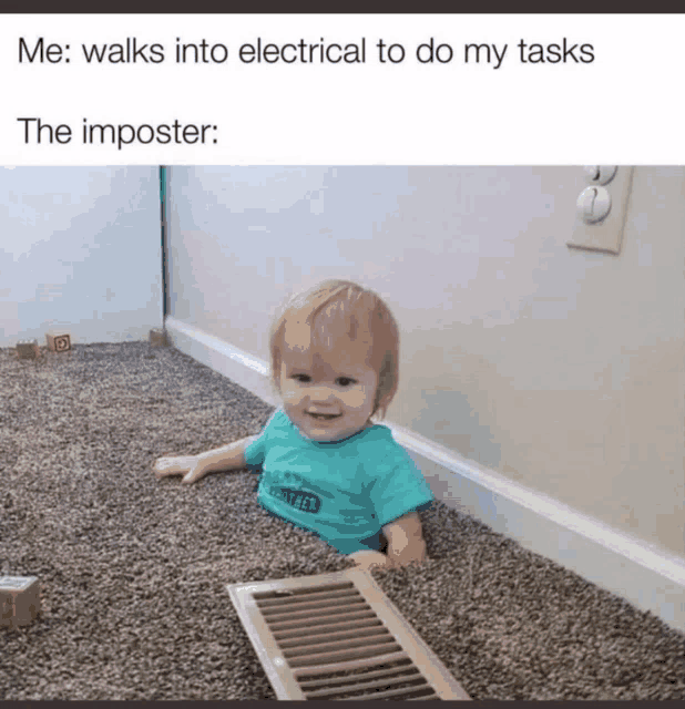 a baby in a blue shirt is laying on the floor next to a vent