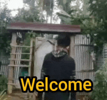 a man is standing in front of a shed with the words `` welcome '' written on the screen .