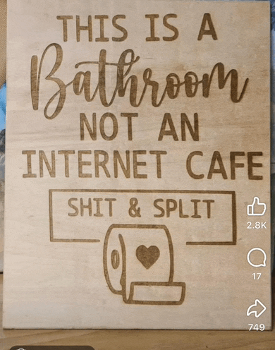 a wooden sign that says this is a bathroom not an internet cafe shit and split