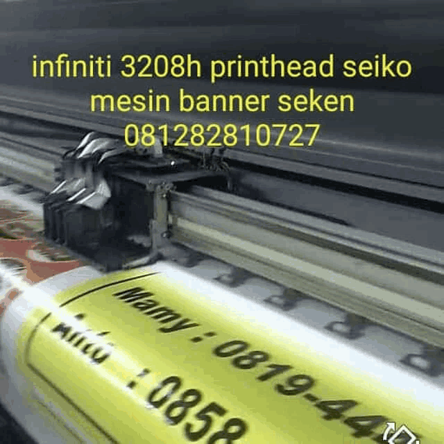 a large yellow banner is being printed on a seiko machine