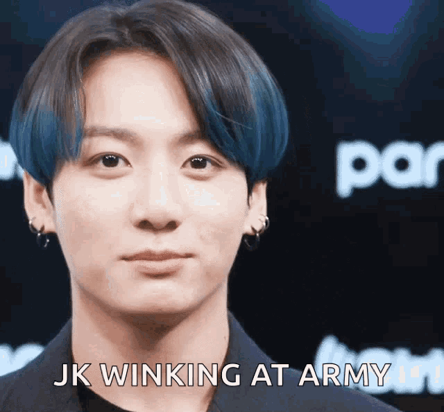 a close up of a person 's face with the words " jk winking at army " below it