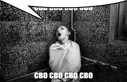 a black and white photo of a person wrapped in a blanket with the words cbo cbo cbo cbo