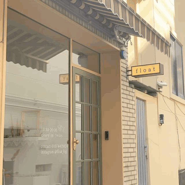 a store front with a yellow sign that says float