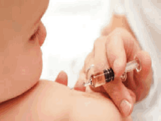 a baby is getting a vaccine from a doctor .