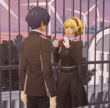 a boy and a girl are standing next to each other on a balcony