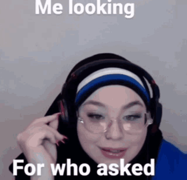 a woman wearing a hijab and headphones is looking for who asked