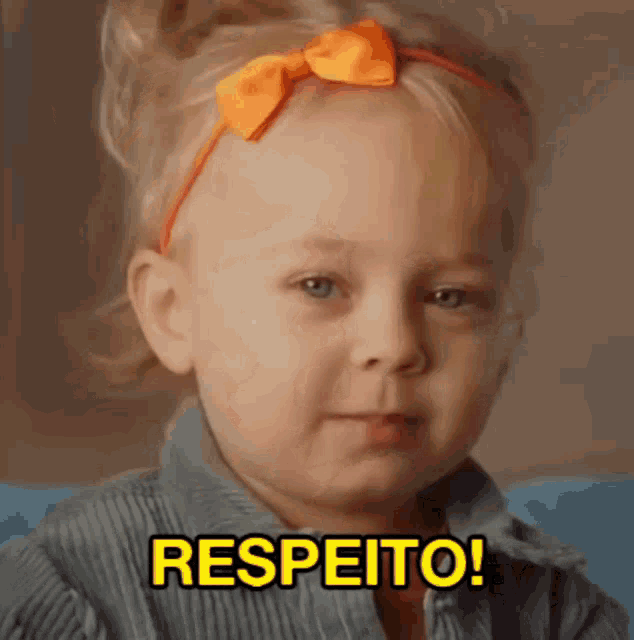 a little girl with an orange bow on her head says respeito !