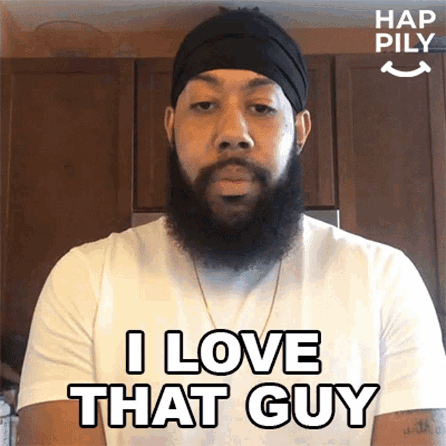 a man with a beard is wearing a white shirt and says i love that guy