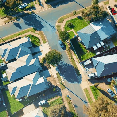 an aerial view of a residential area with lots of houses and cars