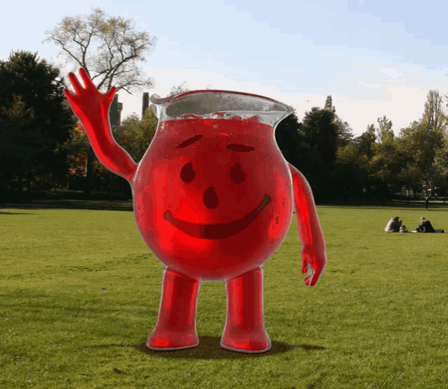 a pitcher of red liquid with a smiling face on it