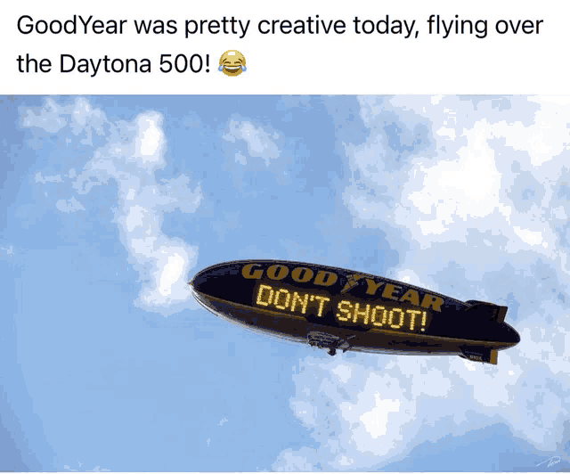 a goodyear blimp is flying in the sky with a message on it