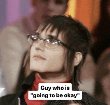 a man wearing glasses and a red turtleneck says " guy who is going to be okay " in a crowd .