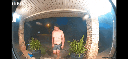 a ring doorbell shows a man in shorts walking in front of a brick building