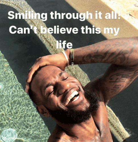 a shirtless man is smiling in front of a pool with the words smiling through it all can 't believe this my life below him