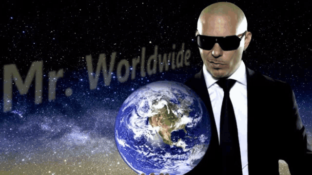 a man in a suit and tie is holding a globe in front of the words mr. worldwide