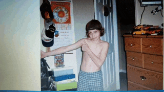 a boy is standing in front of a wall calendar that says october