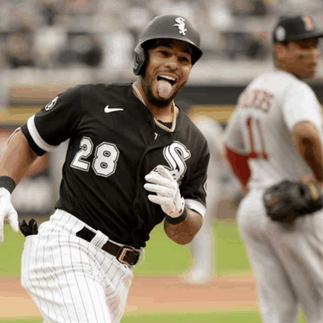 a baseball player with the number 28 on his jersey is smiling