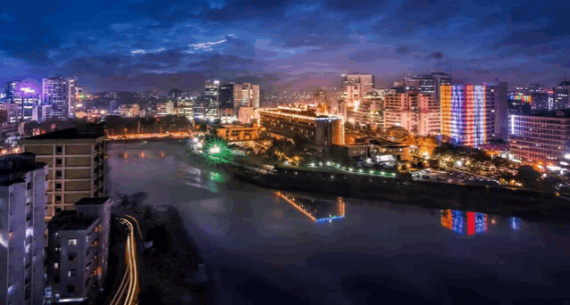 an aerial view of a city at night with a river in the middle