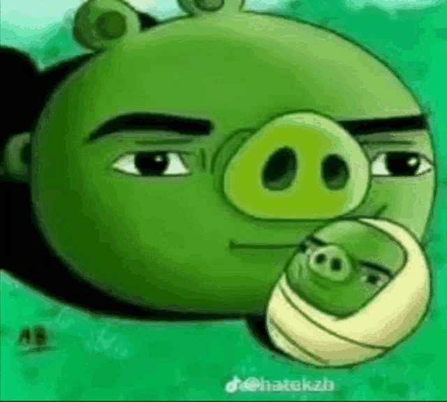 a green angry birds character is holding a baby pig in its mouth .