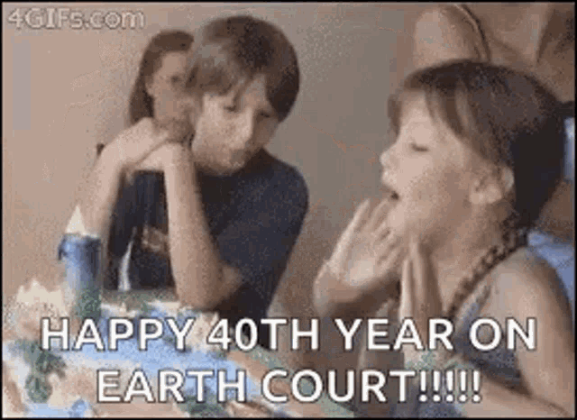 a boy and a girl are sitting at a table with a birthday cake and a message that says happy 40th year on earth court