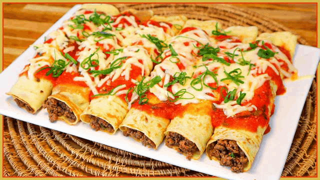 a plate of enchiladas with tomato sauce and cheese